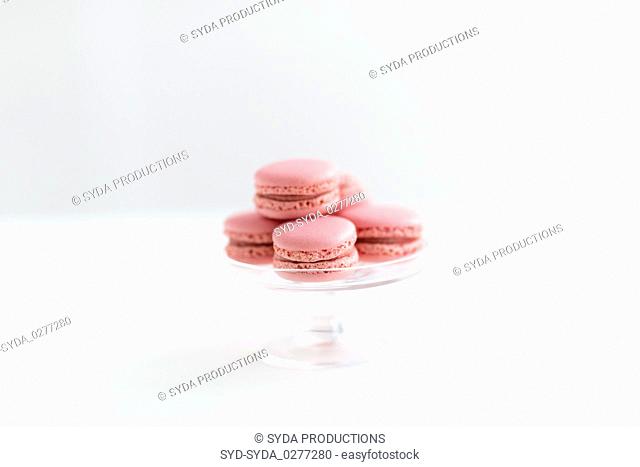 pink macarons on glass confectionery stand