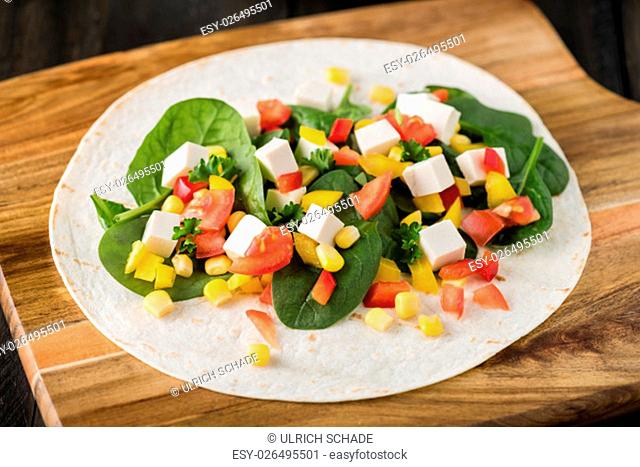vegan tofu wraps with pepper, corn, tomatoes and spinach