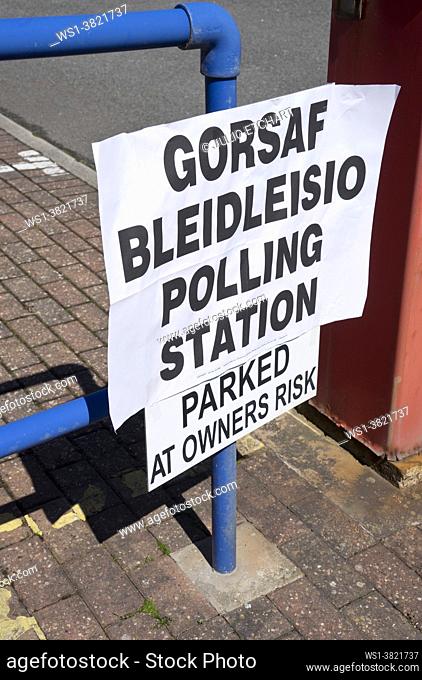 Polling station with bilingual signs in Welsh/English for people to vote for the Senedd / Welsh Parliament elections with precautions due to Coronavirus