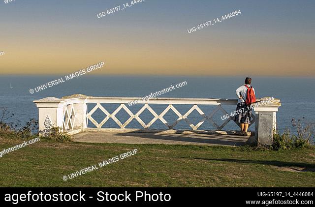 Folkestone, Kent, England, UK. 2020. Woman at a viewpoint overlooking the English Channel at Folkesstone, UK