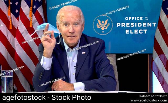 United States President-elect Joe Biden holds a mask while extolling its virtues as he conducts a Virtual Roundtable with Workers and Small Business Owners...