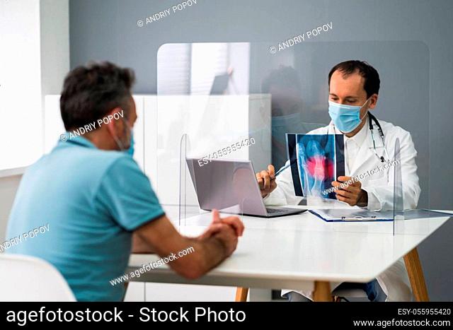 Old Injured Man With Feet Pain At Surgeons Office With Face Mask