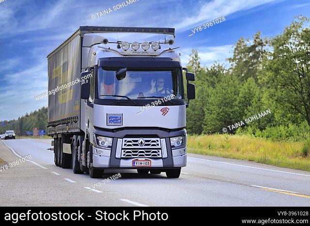 Silver Renault Trucks T lorry G Gronlund pulls LKW Walter trailer on highway 25 on a beautiful day of summer. Raasepori, Finland. July 12, 2019