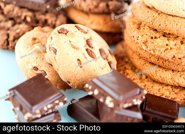 Homemade corded wholegrain cookies with oatmeal, linen and sesame seeds and traditional cookies with chocolate chips and pieces broken chocolate bars with seeds...