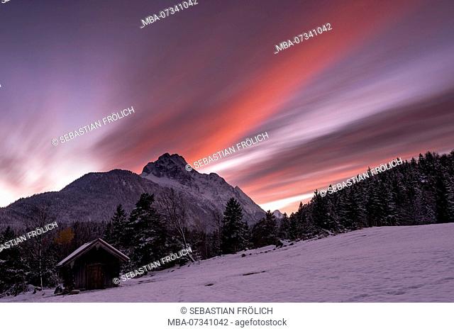 Sunset on the Wetterstein, long exposure of a mountain hut and the Wetterstein Mountains above it after sunset, taken at Mittenwald
