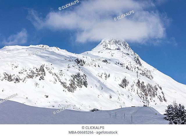 Blue sky frames the snowy peak and ski slopes on a sunny day Bettmeralp district of Raron canton of Valais Switzerland Europe