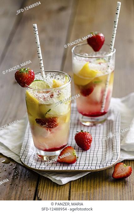 Champagne cocktails with strawberries and mango