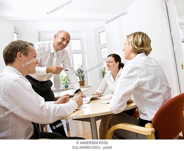 Coworkers talking over a meeting