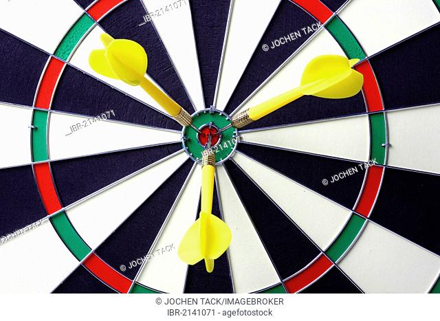 Darts, throwing game, darts sticking into the middle of the dartboard, the bullseye