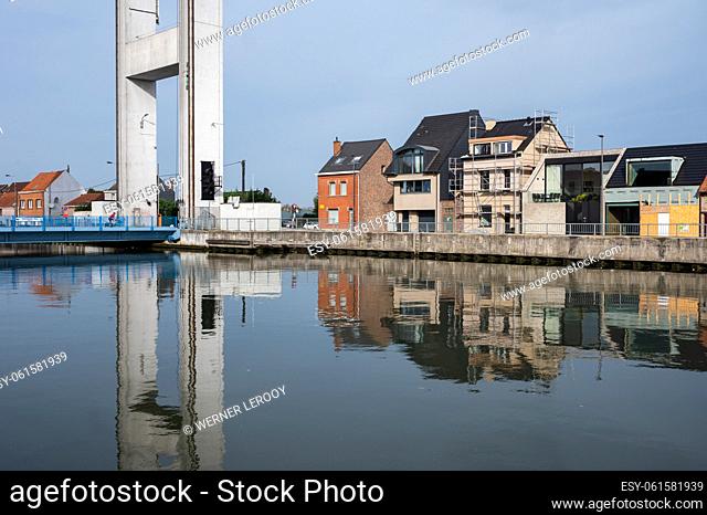 Humbeek, Flemish Brabant Region, Belgium - Suspension bridge at the sea canal with residential houses reflecting in the water