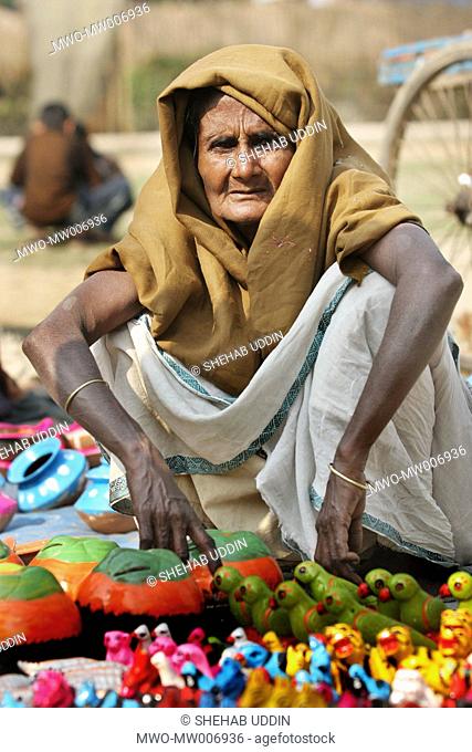 Portrait of an old woman selling clay toys at a fair held during the Eid-ul-Adha festival in a village Mayshaghuni, Rupsha, Khulna, Bangladesh January 01