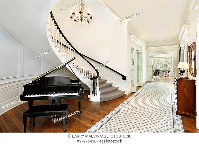 Foyer in traditional home with curved staircase