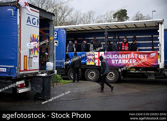 PRODUCTION - 12 April 2023, Hesse, Weiterstadt: ""Solidarity is stronger"" is written on a banner during a strike by truck drivers of a Polish logistics company...