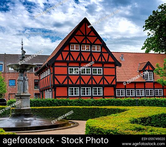 Aalborg, Denmark - 7 June, 2021: historic red half-timbered house and the Kayerod fountain in the old town city center of Aalborg