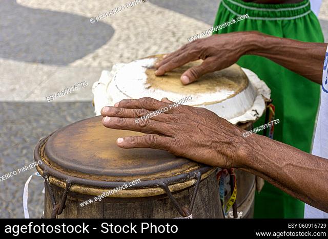 Percussionist playing a rudimentary atabaque during afro-brazilian cultural manifestation at Pelourinho on Salvador city, Bahia