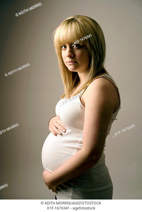a pregnant young teenage blonde haired girl woman