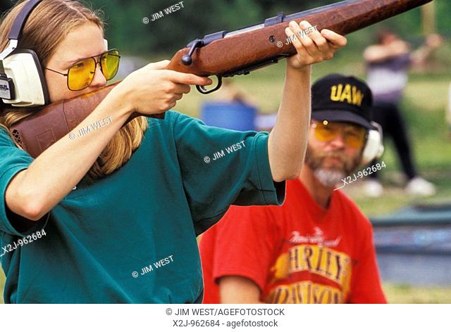 Detroit, Michigan - Mullaney Hardesty practices shooting her deer hunting rifle at a shooting range near Detroit as her dad, Mark Hardesty, watches