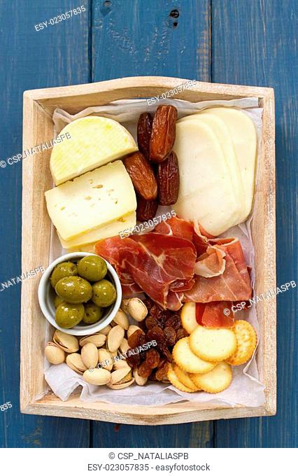 cheese with prosciutto, bread, dry fruits