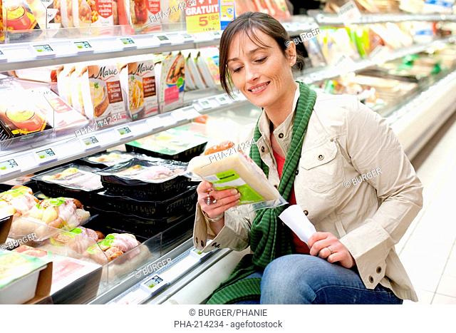 Woman shopping in the prepared food section in supermarket