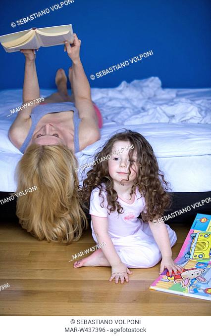 mother and daughter reading book