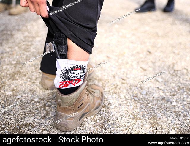 RUSSIA, GUDERMES - FEBRUARY 27, 2023: A student shows a weapon hidden in her sock during a session of the ""Female Bodyguard"" close protection course at...