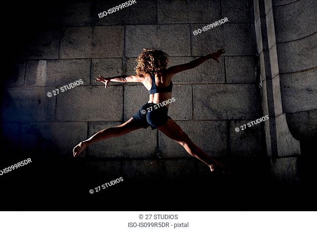 Woman jumping with legs and arms open