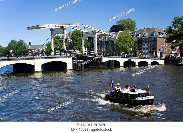 Leisure Boat, Magere Brug, Amstel, View over Amstel with leisure boat to Magere Brug Skinny Bridge, Amsterdam, Holland, Netherlands