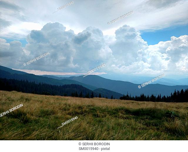 Mountains ate clouds and lawn Grassland with dry grass nature