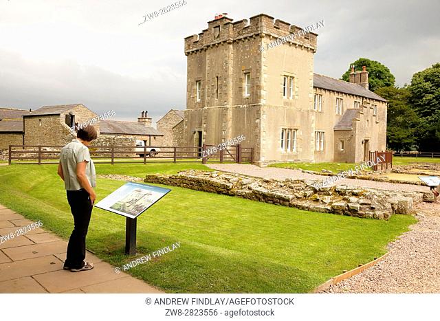 Woman reading information sign. Banna, Birdoswald Roman Fort, Cumbria, England, United Kingdom, Europe