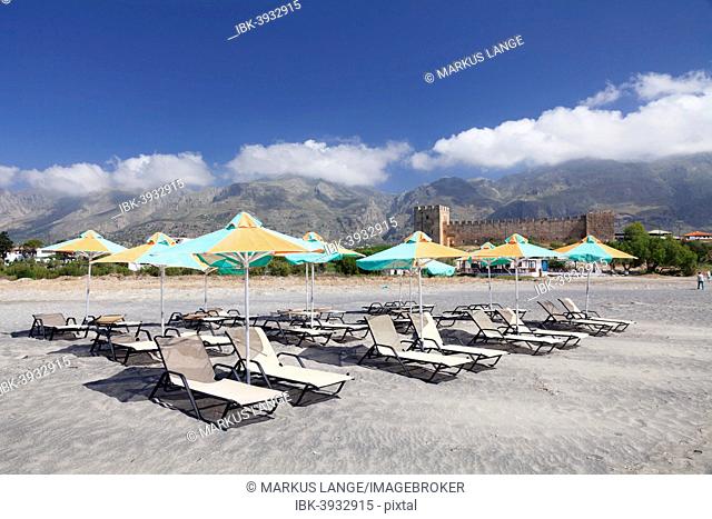 Beach with sun beds, the Venetian castle at the back, Frangokastello, Crete, Greece