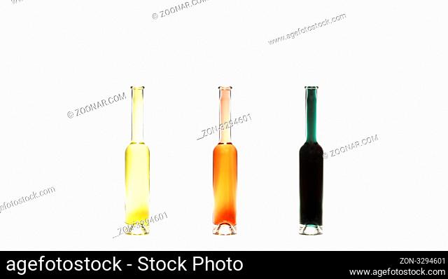 drei duenne flaschen mit verschiedenen fluessigkeiten auf weissen hintergrund