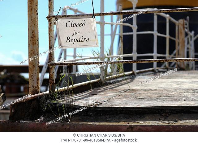 Grass and a sign saying 'closed for repairs' can be seen on the weathered deck of the museum ship 'Peking' (lit. Beijing) at the transport ship 'Combi Dock III'...
