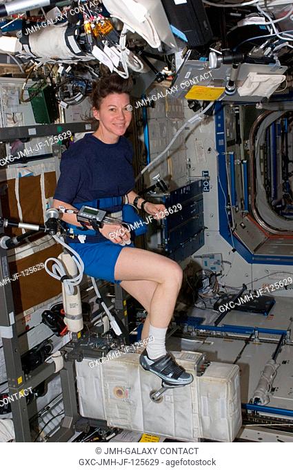 NASA astronaut Catherine (Cady) Coleman, Expedition 26 flight engineer, exercises on the Cycle Ergometer with Vibration Isolation System (CEVIS) in the Destiny...