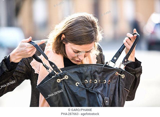 Woman looking into her handbag