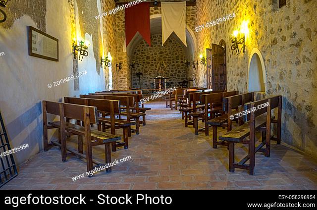 Interior of a medieval castle in Toledo, Spain. Stone rooms with wooden furniture, medieval period of the Spanish reign