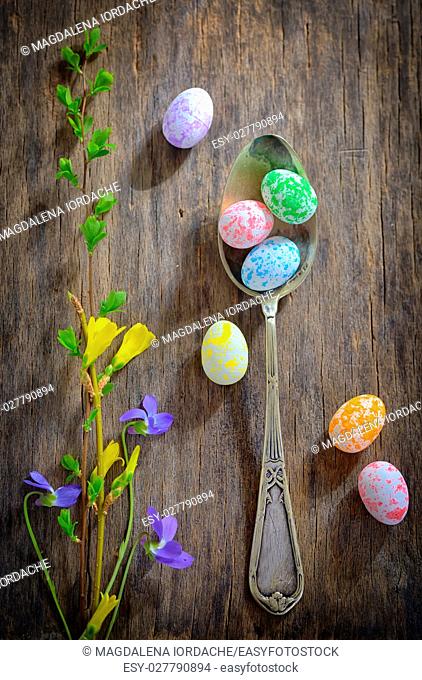 Easter wooden table setting with eggs and flowers