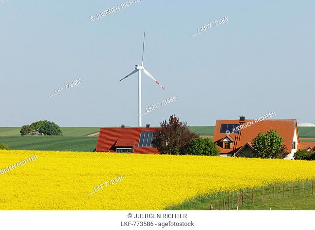 Wind turbine, houses with solar cells, photovoltaic cells, rapeseed field, bio-energy, renewable energy, near Gunzenhausen, Mittelfranken, Lower Franconia