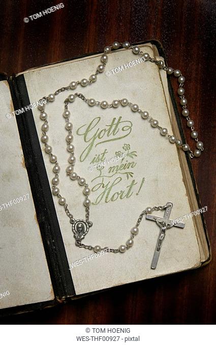 Prayer book and rosary, elevated view