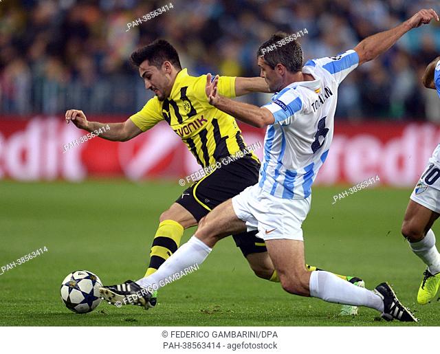 Dortmund's Ilkay Guendogan (L) and Malaga's Jeremy Toulalan vie for the ball during the UEFA Champions League quarter final first leg soccer match between...