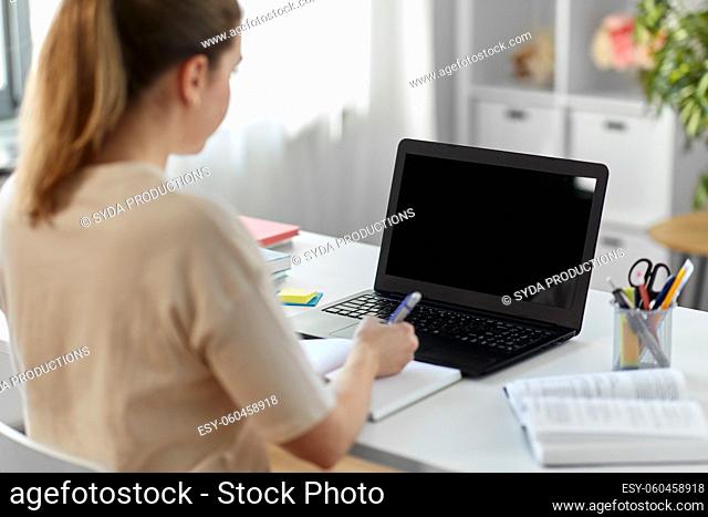 student woman with laptop, notebook and book