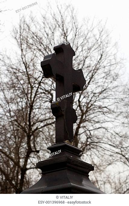 Black marble orthodoxal cross-shaped tombstone