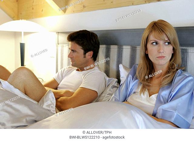 couple quarreling in bed