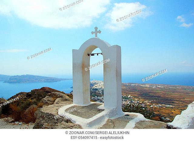 A small white bell tower on the island of Santorini in the Aegean Sea