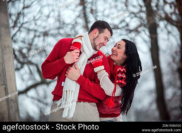 beautiful young couple posing in a snowy park, close view