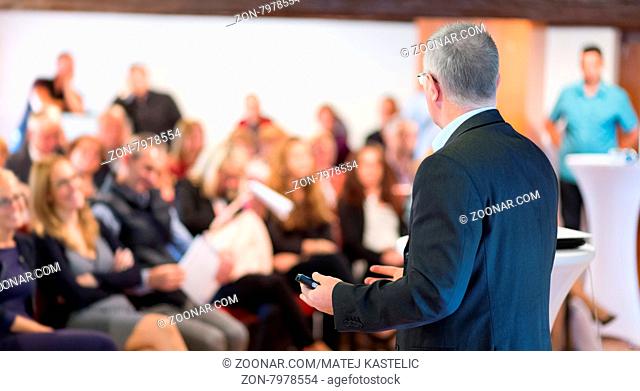 Speaker at Business Conference with Public Presentations. Audience at the conference hall. Entrepreneurship club. Rear view. Horisontal composition