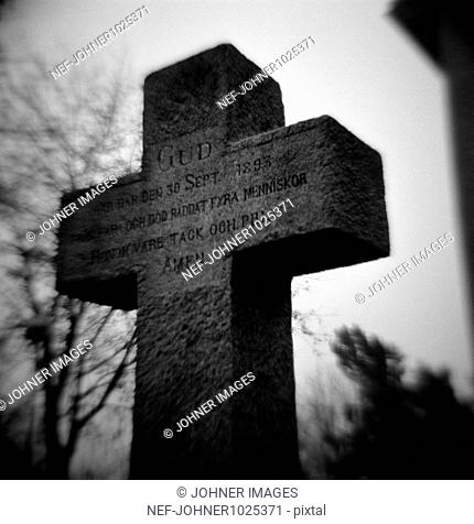 Cross on graveyard, selective focus