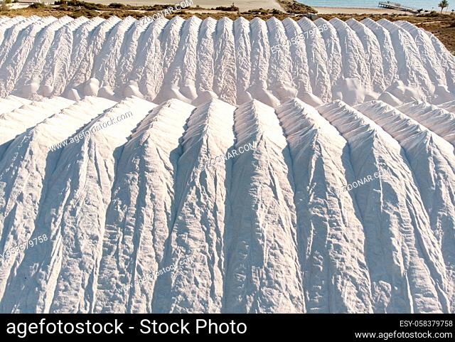 Aerial drone point of view white heaps of natural salt in Santa Pola. Province of Alicante. South of Spain, Europe. Production, industry concept