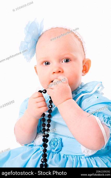 Adorable Baby Girl playing with beads isolated on white