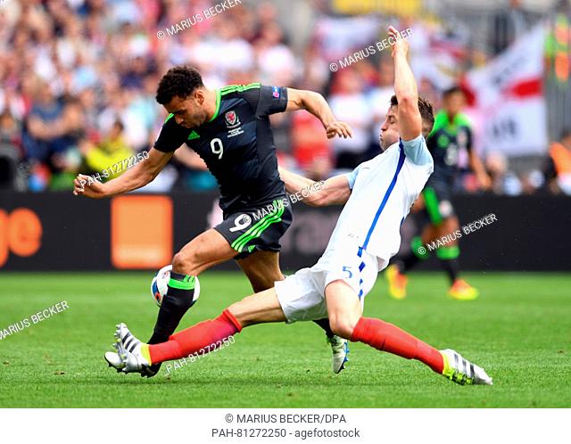 Gary Cahill (r) of England and Hal Robson-Kanu (L) of Wales challenge for the ball during the Euro 2016 Group B soccer match between England and Wales at the...
