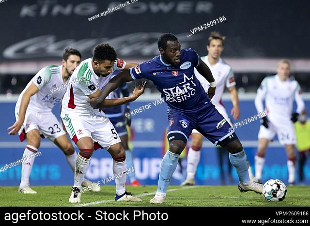 OHL's Pierre Yves Ngawa and Mouscron's Harlem Gnohere fight for the ball during a soccer match between Oud-Heverlee Leuven and Royal Excel Mouscron